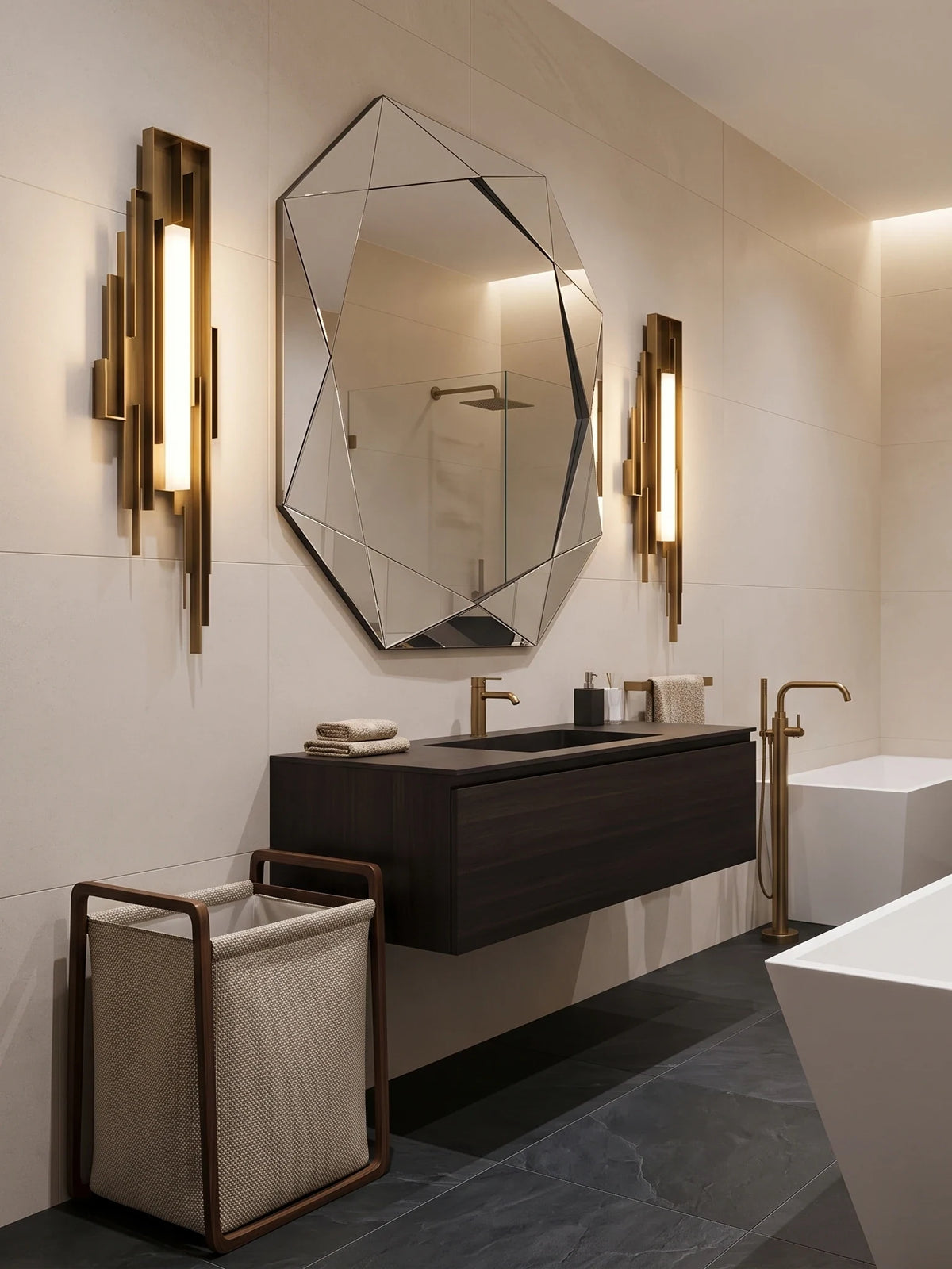 Deux appliques murales longues dorées Guimard de part et d'autre d'un miroir octogonal, dans une salle de bain au plan de toilette en bois sombre
