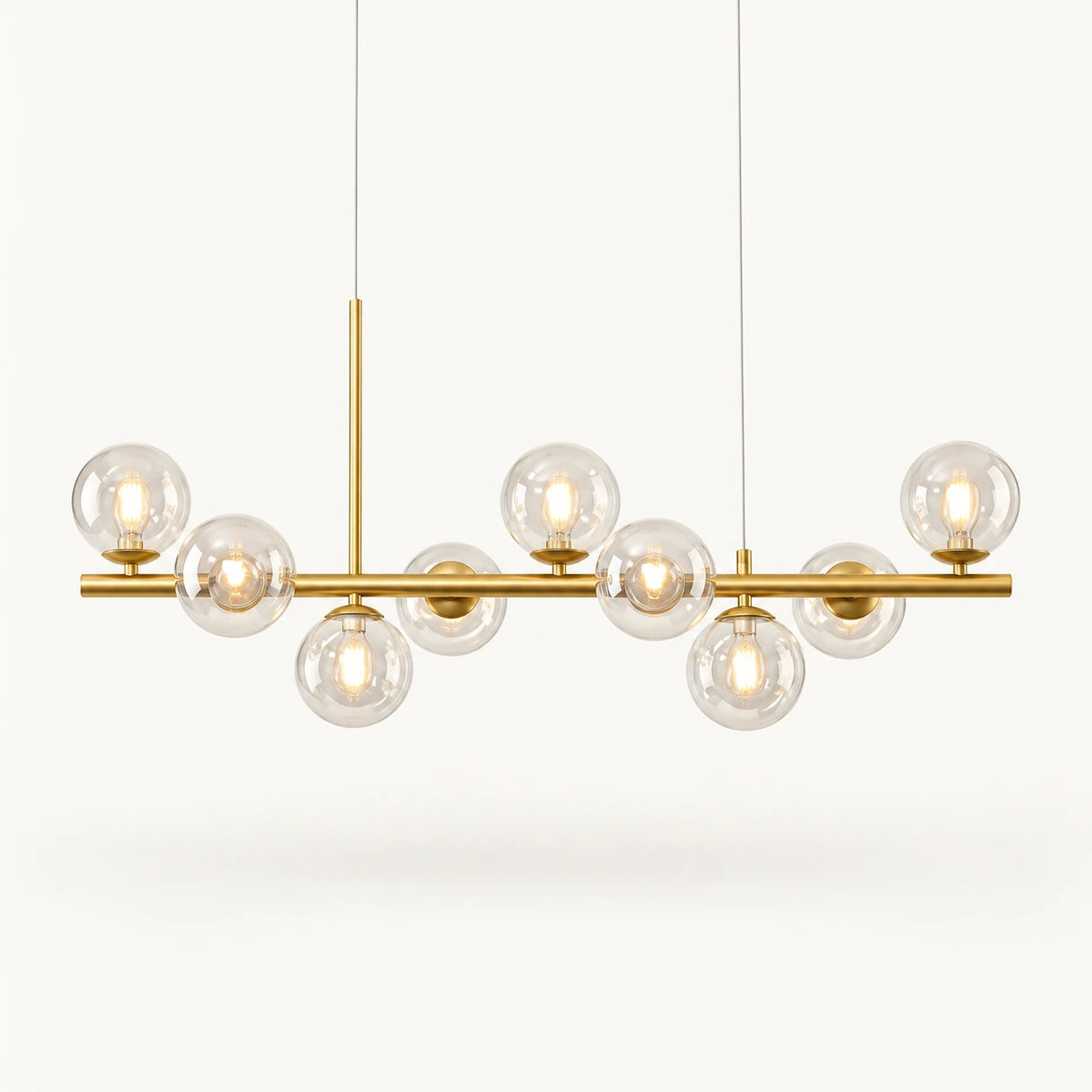 Globes de verre transparent et ampoules G9 visibles, sur barre doré satiné