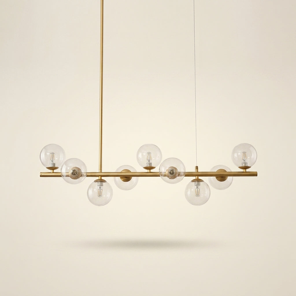 Globes de verre transparent et ampoules G9 visibles, sur barre doré satiné